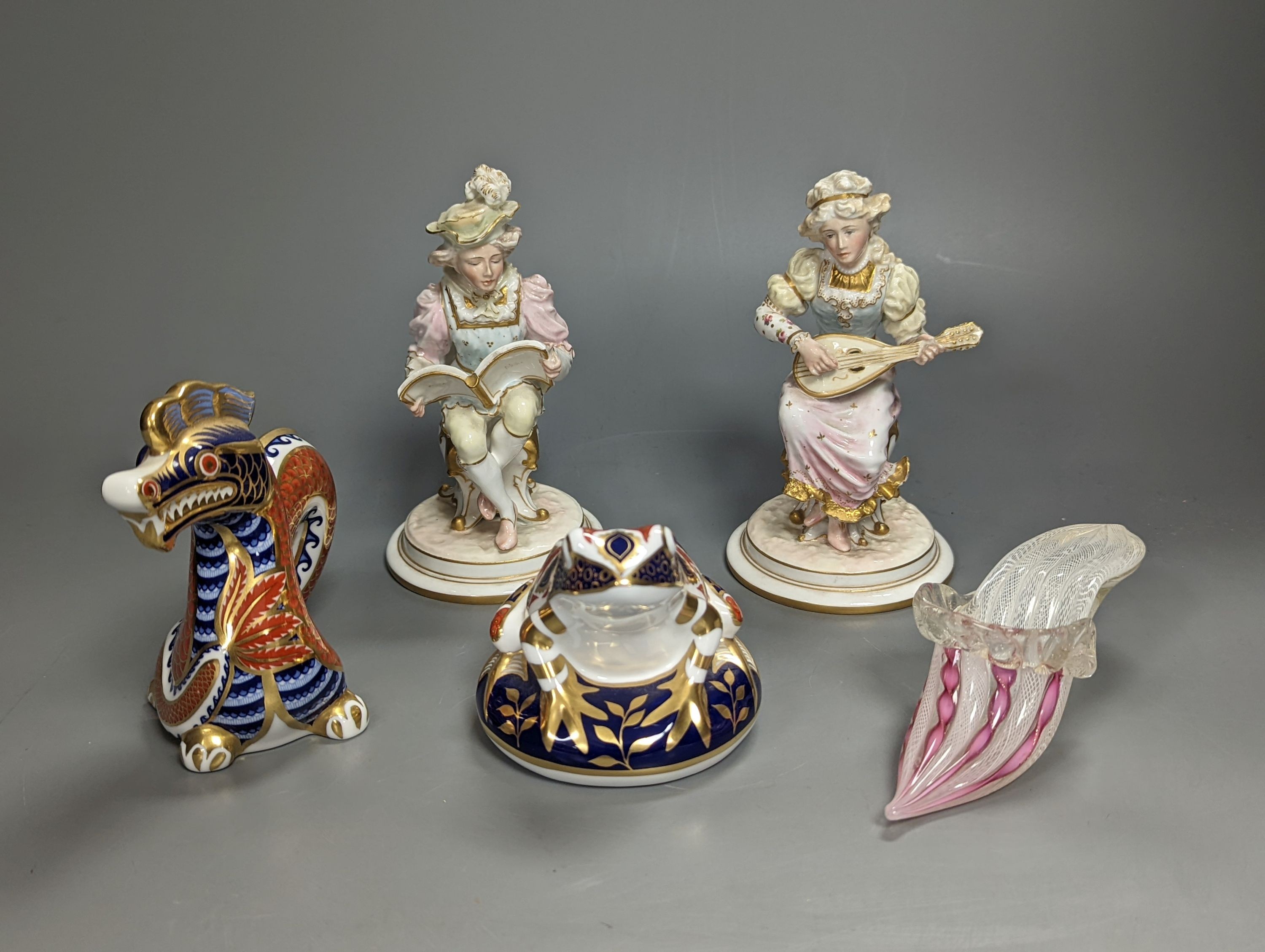 A pair of Royal Crown Derby figures of musicians, c.1905, 15cm, two similar animal paperweights and a Latticino glass slipper, tallest being the dragon 11cm